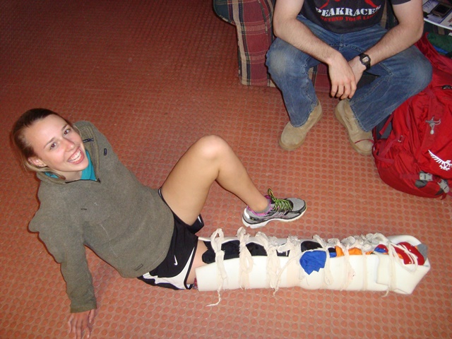 SOLO student shows off her immobilizing lower leg splint: rigid device, lots of padding including the voids, tied tightly every two inches using bows.