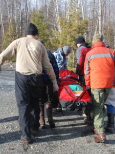 A rescue team carries a patient in a l.itter